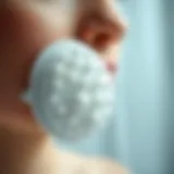 Close-up view of an electric silicone face scrubber showcasing its design and texture.