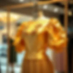 Elegant display of a gold puff sleeve dress on a mannequin
