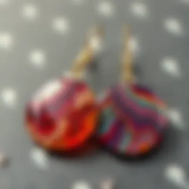 A finished pair of resin earrings, elegantly showcasing intricate patterns and glossy finish